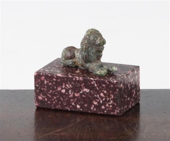 A small Roman bronze figure of a recumbent lion, c.2nd century AD, 5cm